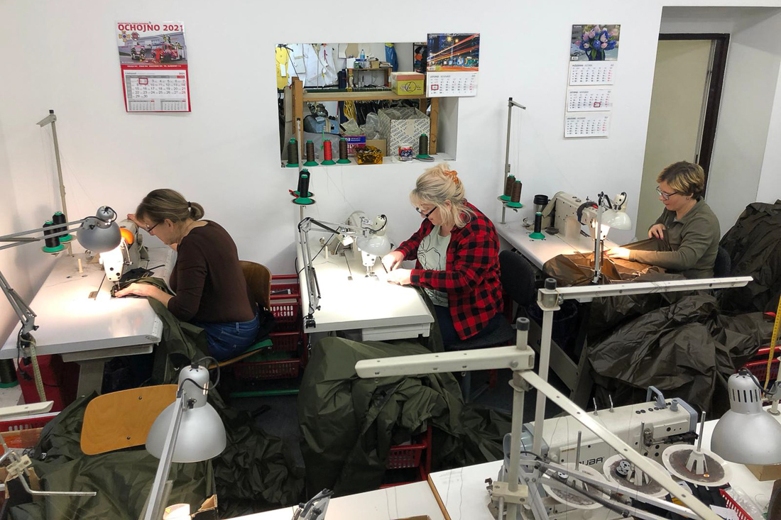 Seamstresses working on Lesovik tarpaulins.